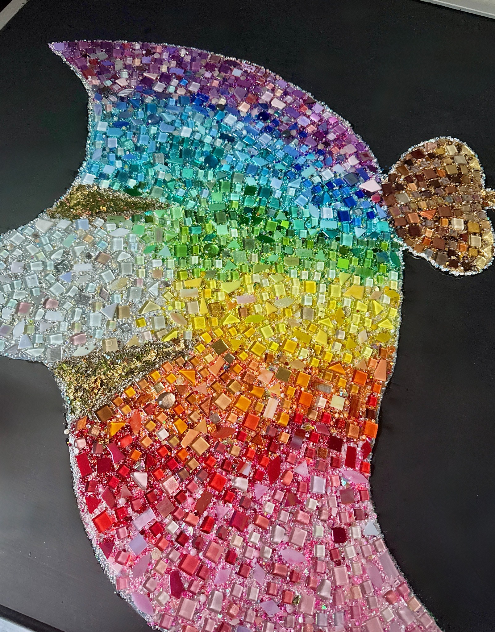 Close-up of colorful manta ray mosaic with beads, glass, and gems